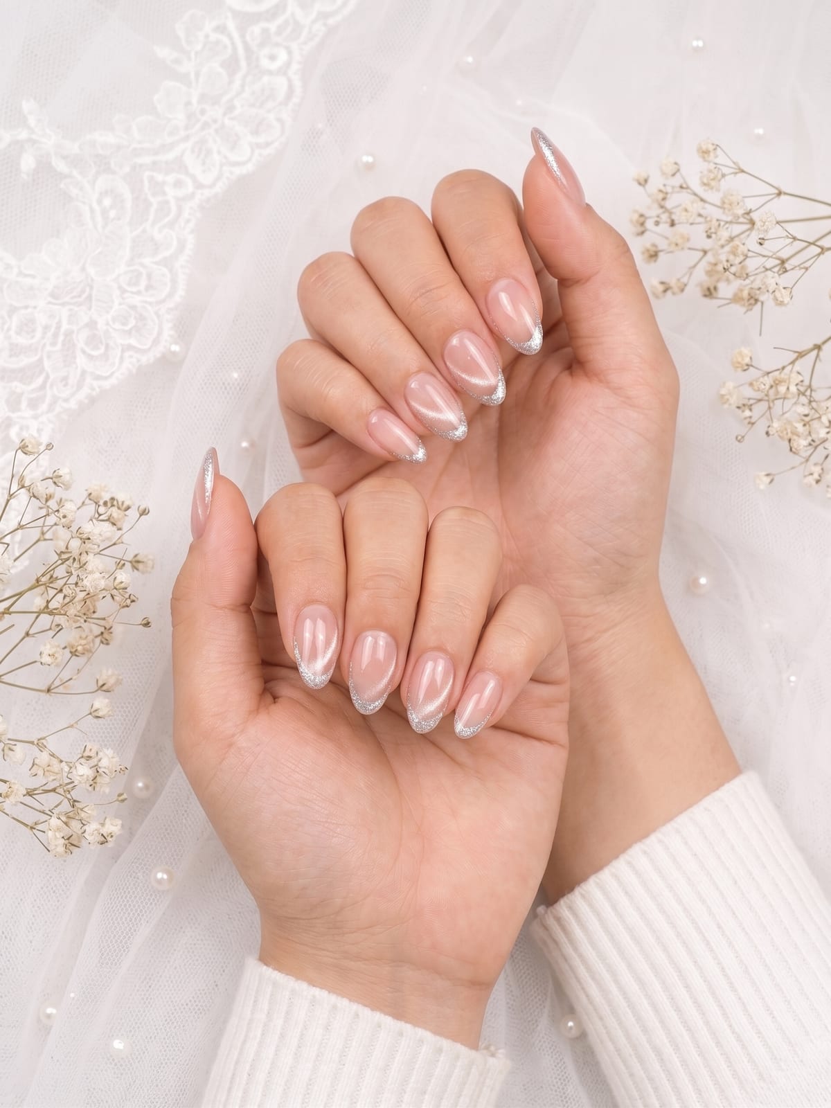 Glitter French tip nails on a bridal-styled hand
