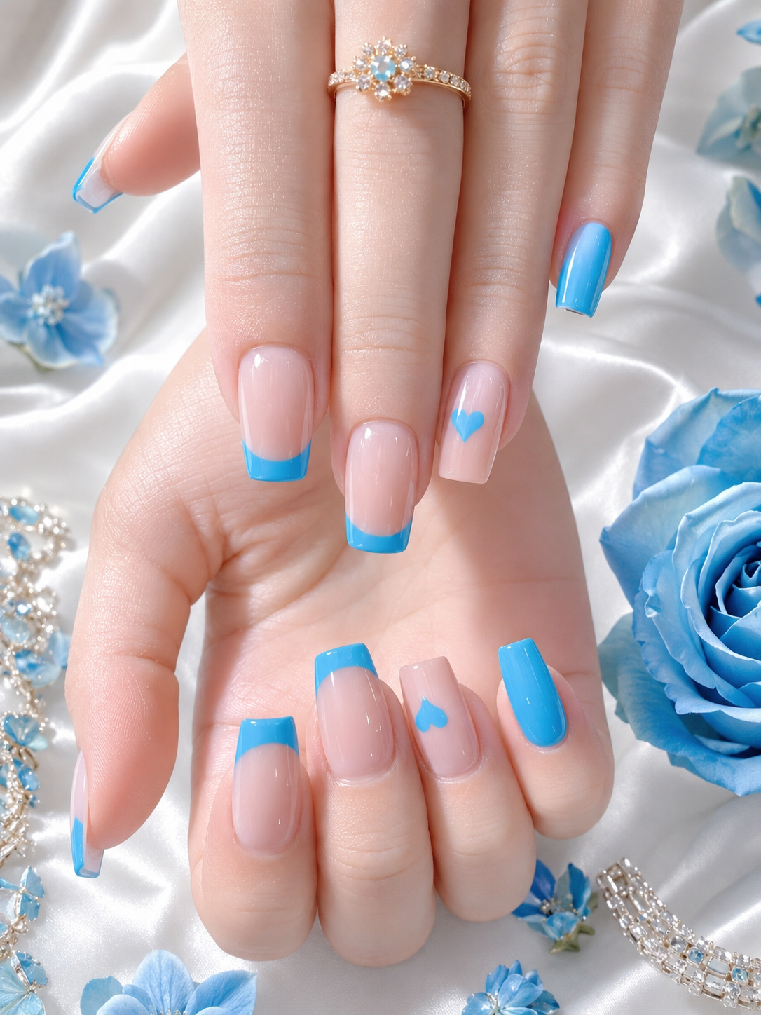 Light blue French tip nails with a heart accent design