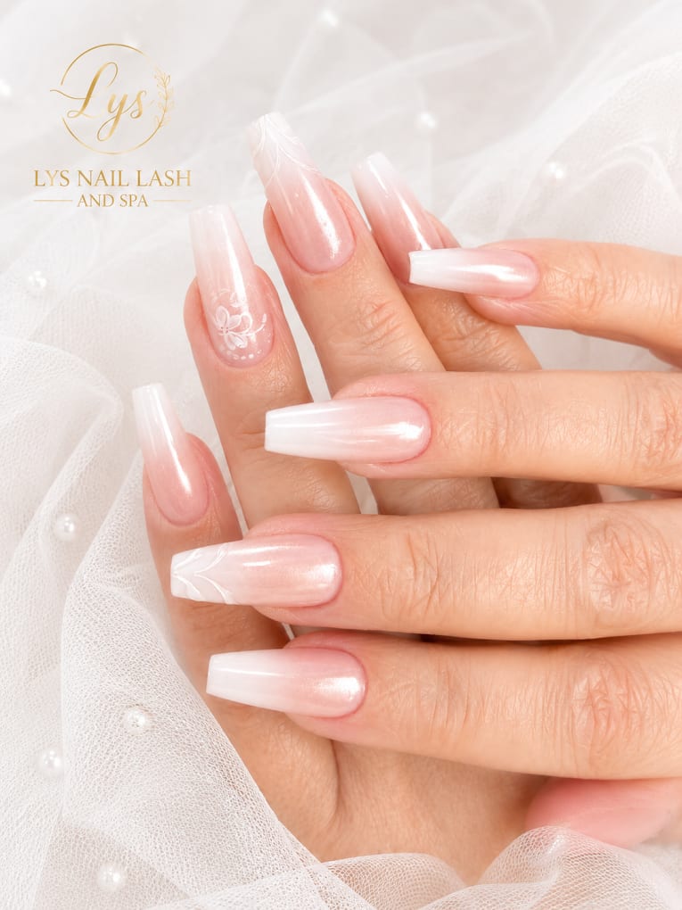 Pearlescent white ombre nails with a subtle floral accent