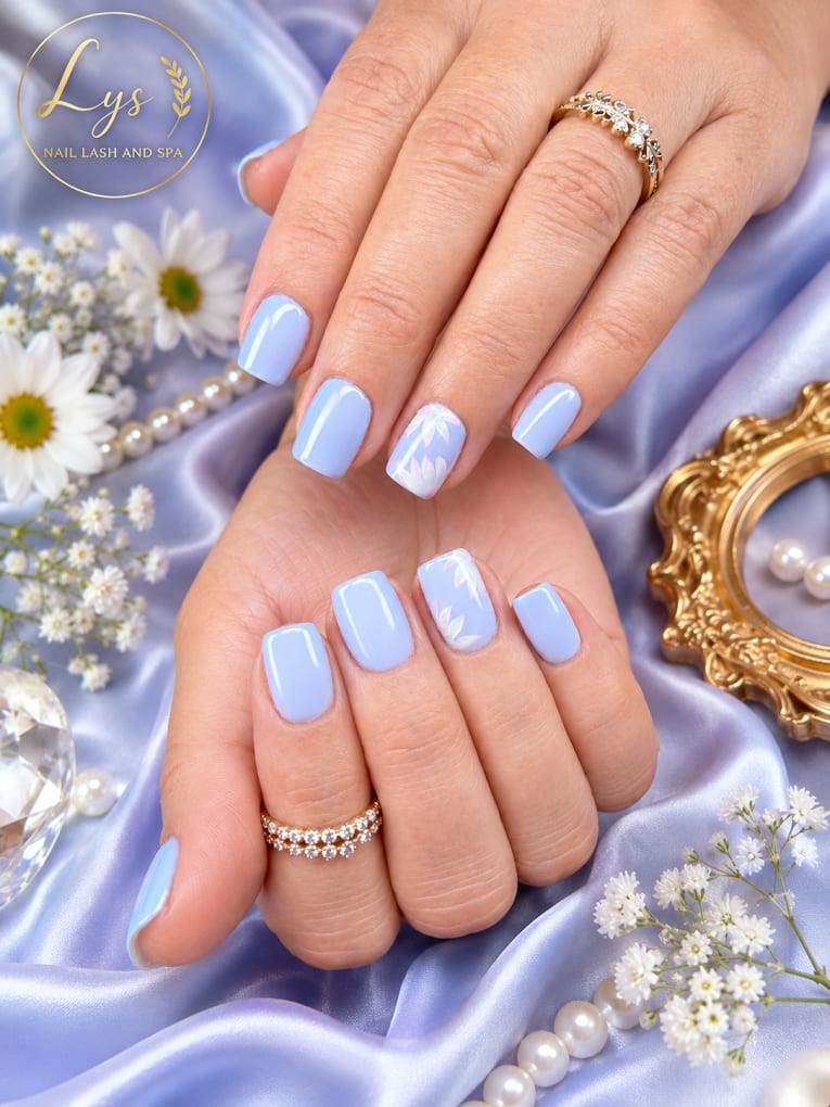 Light blue nail art with white floral accents