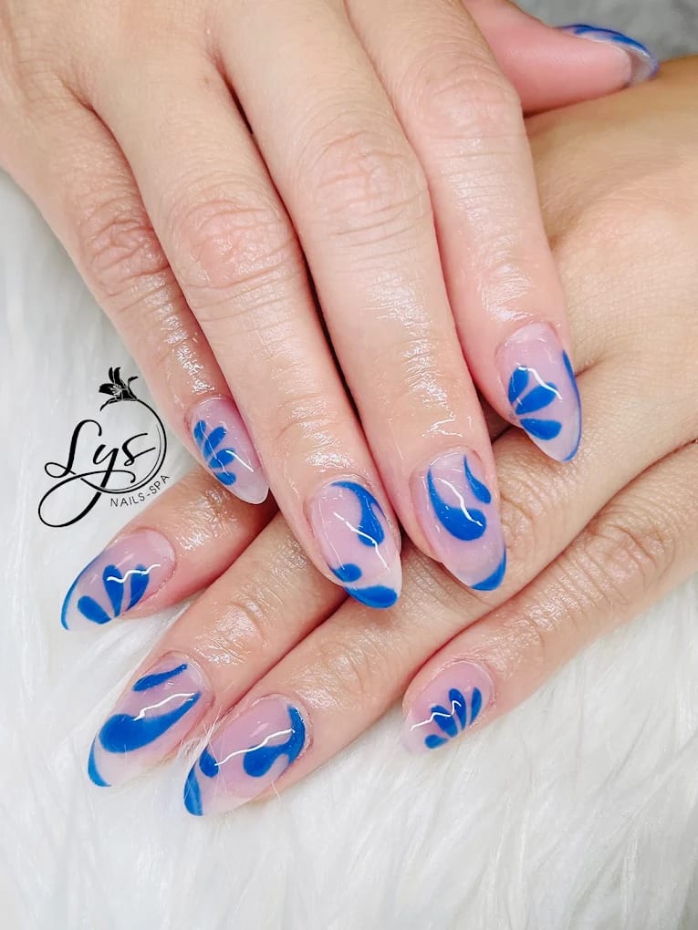Blue abstract nail art on a sheer base