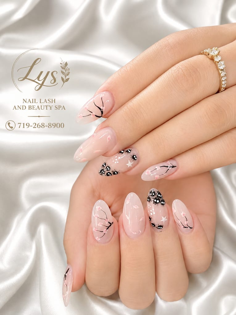 Nude nails with hand-painted black cherry blossom branches and star accents