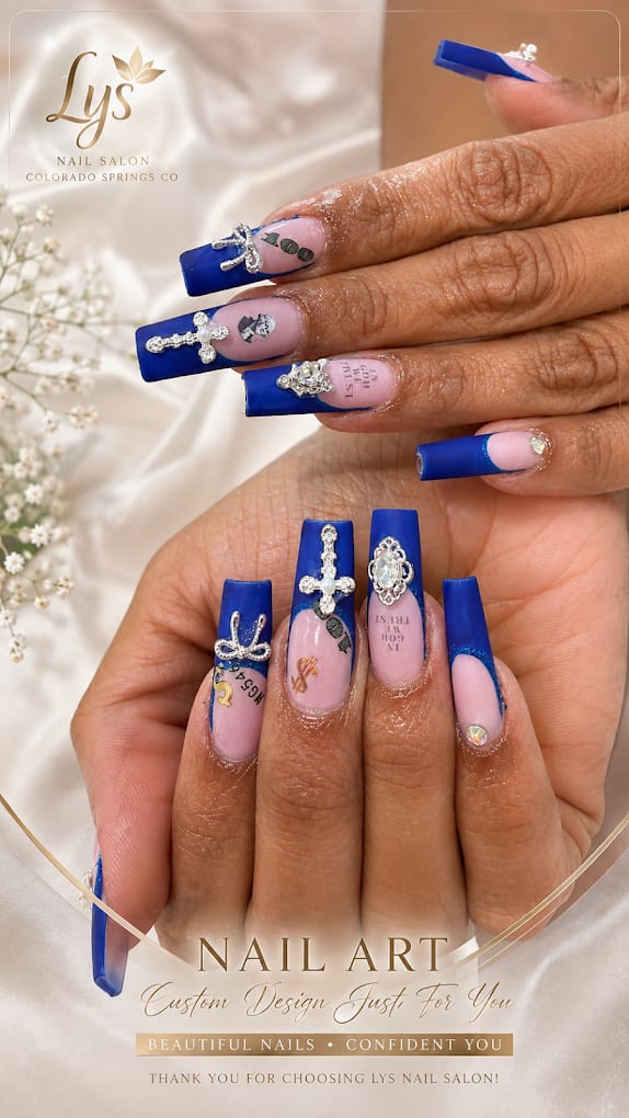 Long blue coffin nails with rhinestone crosses and custom lettering nail art