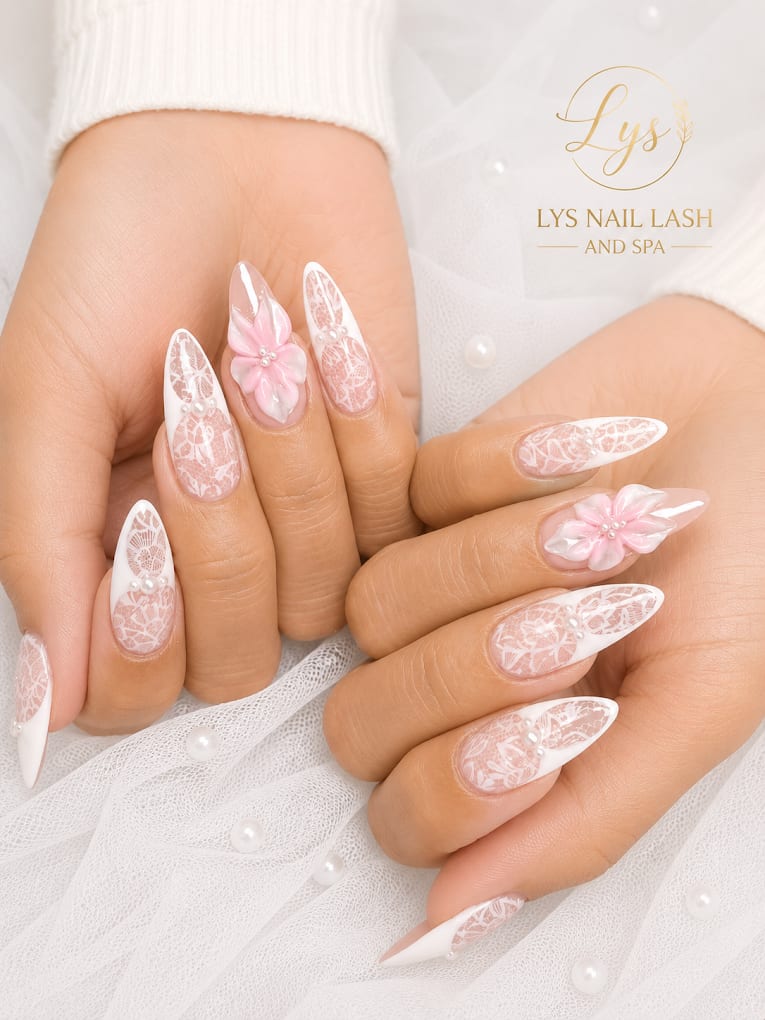 White lace-pattern French tips with pink 3D floral accents and pearls