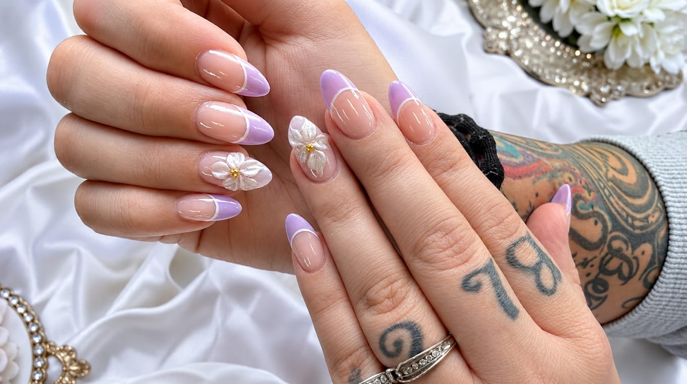 Lavender French tip nails with white 3D floral accents