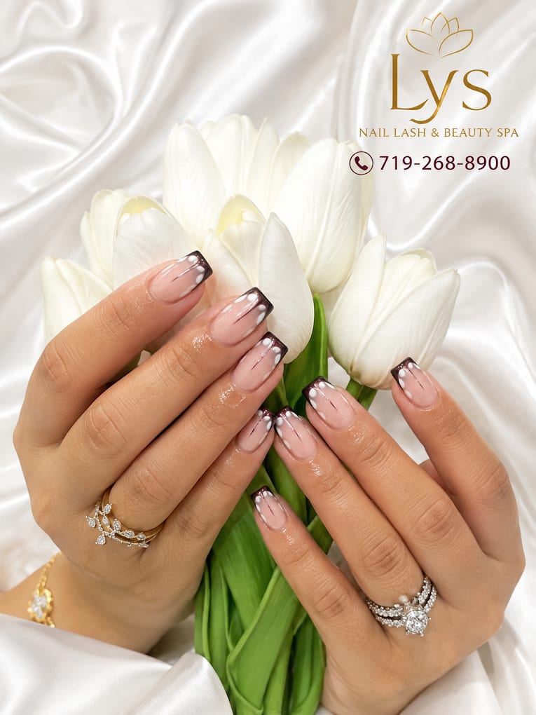 Dark red outline French tip nails with a white tulip bouquet